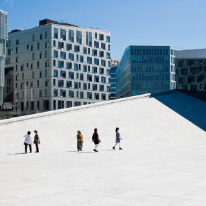 Five tourists walking on the roof of Opera House in Oslo, modern architecture, people, minimalism